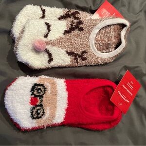 Two pairs of Christmas holiday grip socks -Cozy Reindeer and Santa glasses red